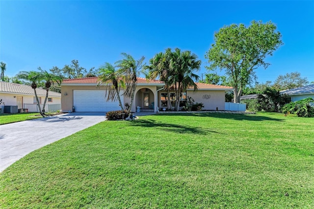 mediterranean / spanish-style house with a garage, a front lawn, and central air condition unit