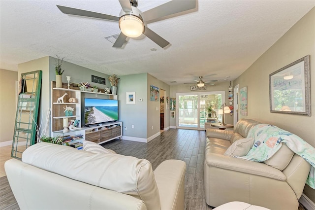 living room featuring a textured ceiling, dark hardwood / wood-style floors, and ceiling fan