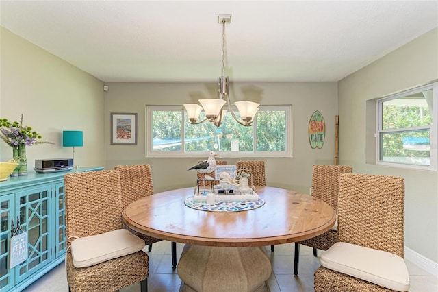 dining space featuring a notable chandelier, tile patterned floors, and plenty of natural light