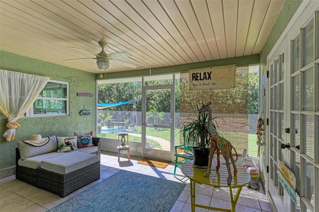 sunroom with ceiling fan and outdoor lounge area