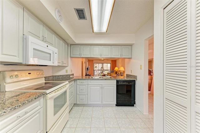 kitchen featuring light tile patterned floors, white appliances, and sink