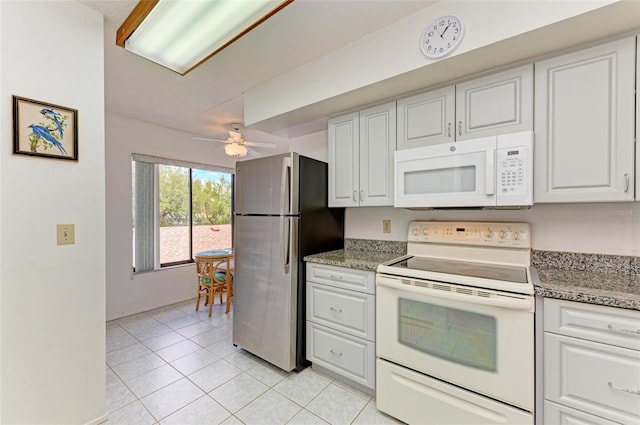 kitchen with white cabinets, ceiling fan, white appliances, and light tile patterned floors