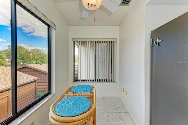 sunroom / solarium featuring ceiling fan