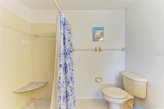 bathroom with tile patterned floors, toilet, and walk in shower