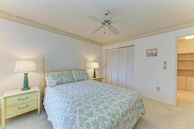 bedroom with crown molding, ceiling fan, a closet, and light colored carpet