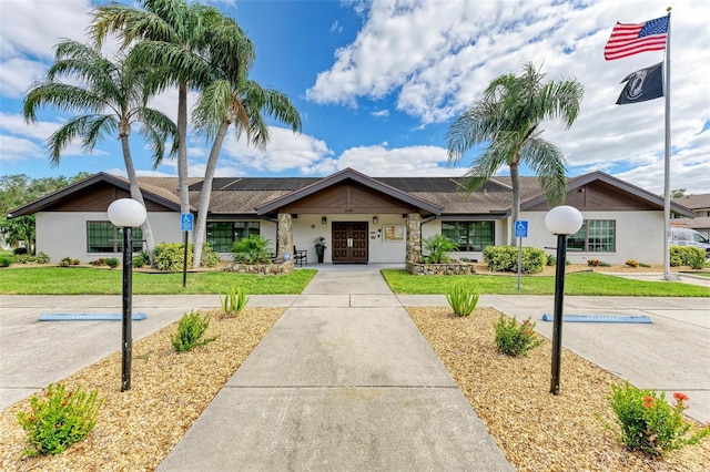 ranch-style home featuring french doors and a front yard