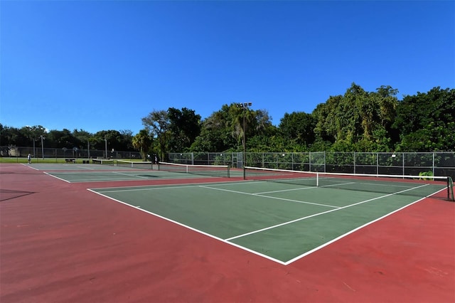 view of tennis court with basketball hoop