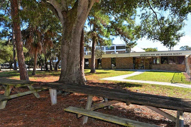 view of property's community with a lawn