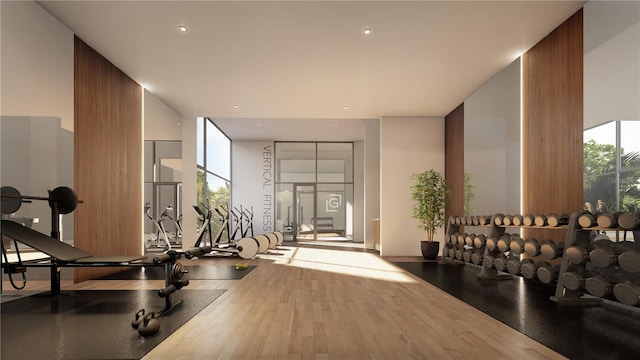 workout area with floor to ceiling windows and wood-type flooring