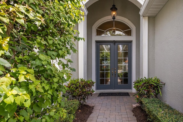 view of exterior entry featuring french doors