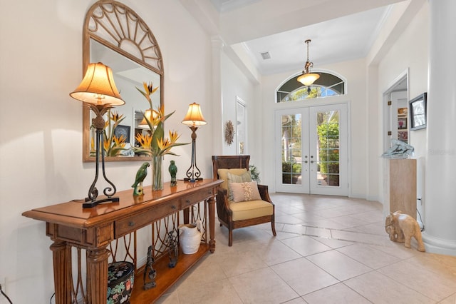 sitting room featuring light tile patterned floors, ornamental molding, and french doors