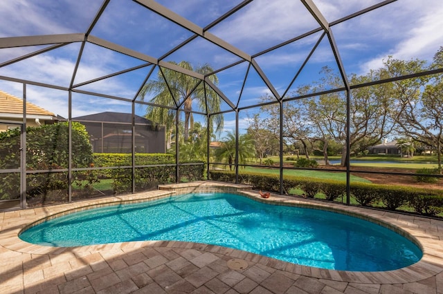 view of swimming pool featuring glass enclosure