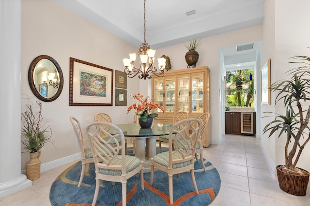 tiled dining room with beverage cooler and an inviting chandelier