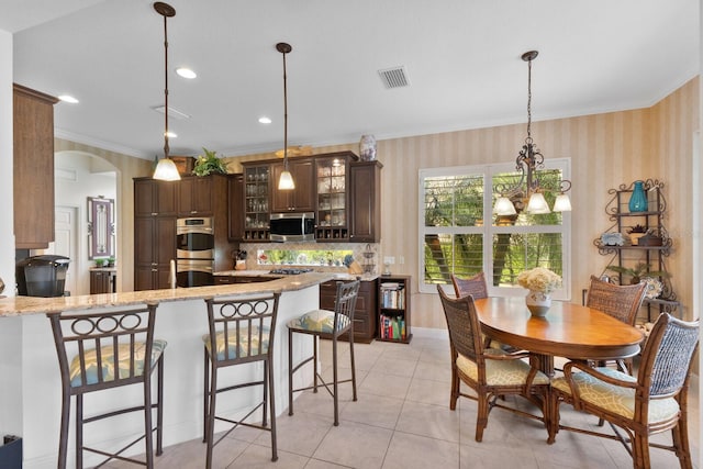 dining area with crown molding and light tile patterned floors