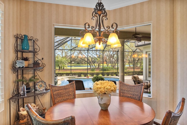 dining area featuring a chandelier, a healthy amount of sunlight, and ornamental molding