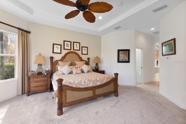 bedroom with light carpet, multiple windows, and ceiling fan