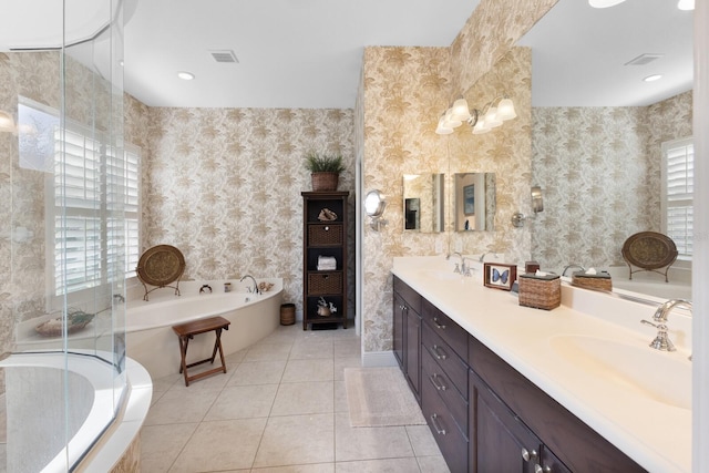 bathroom featuring vanity, tile patterned flooring, and a relaxing tiled tub