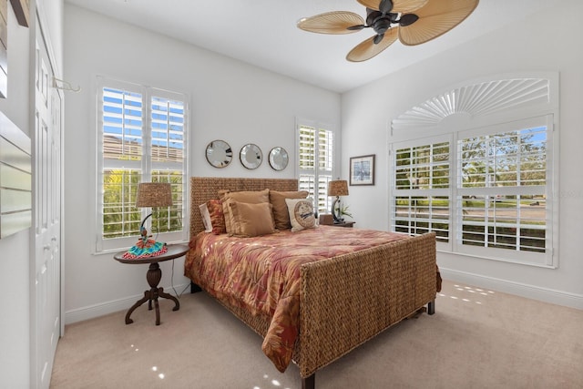 bedroom with light carpet, a closet, and ceiling fan