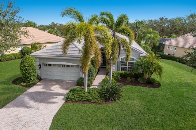 view of front of home featuring a garage and a front lawn