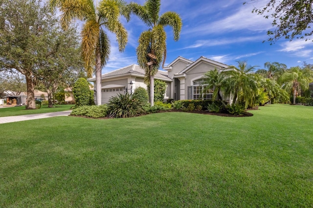 view of front of home with a front yard and a garage