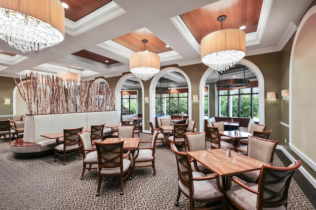 dining area with a chandelier, carpet floors, crown molding, and coffered ceiling