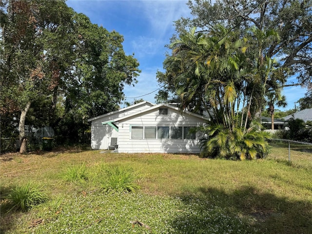 view of side of property with a yard