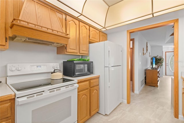 kitchen with custom range hood and white appliances