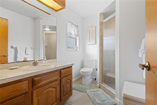 bathroom with toilet, an enclosed shower, and vanity