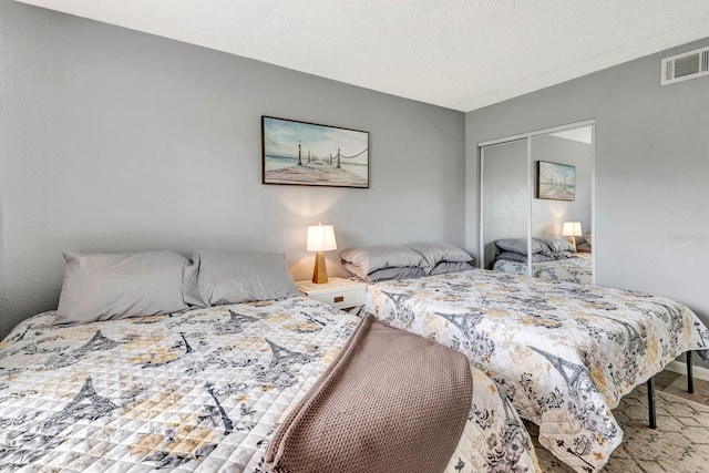 bedroom with a closet and a textured ceiling