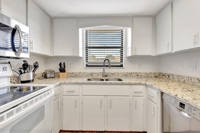 kitchen with white cabinets, appliances with stainless steel finishes, and sink