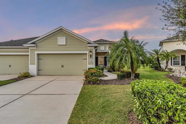 single story home with a yard and a garage