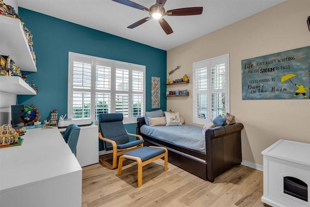 bedroom with ceiling fan and light wood-type flooring