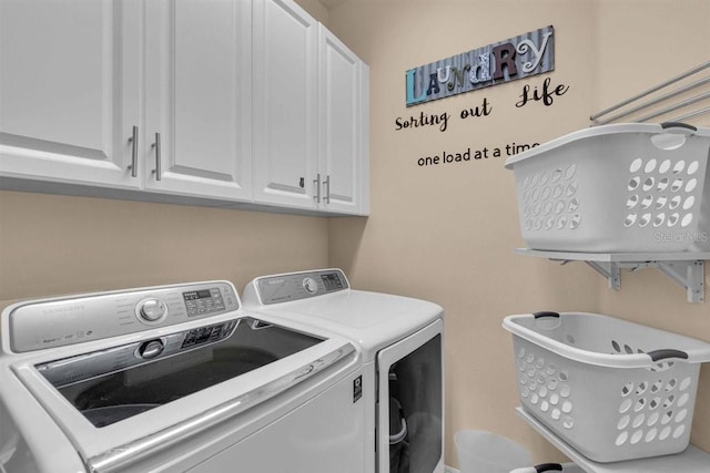 washroom with cabinets and independent washer and dryer