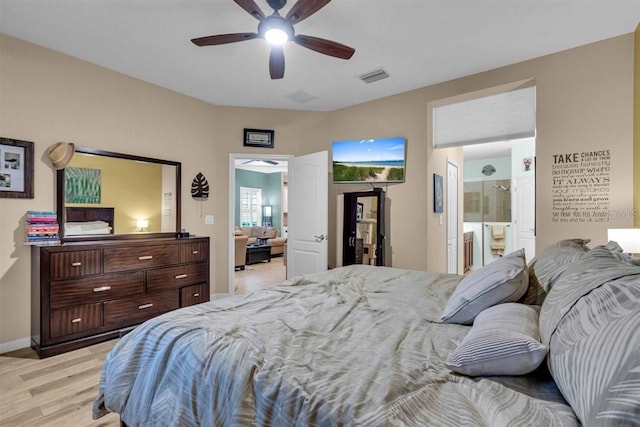 bedroom with ensuite bathroom, ceiling fan, and light wood-type flooring