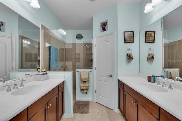 bathroom with tile patterned floors, vanity, and walk in shower