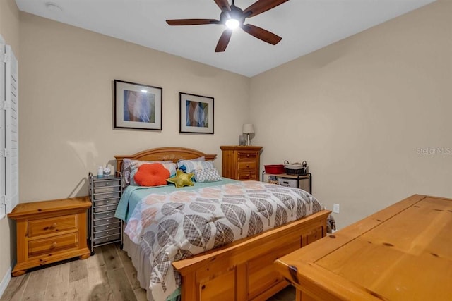 bedroom with light hardwood / wood-style floors and ceiling fan