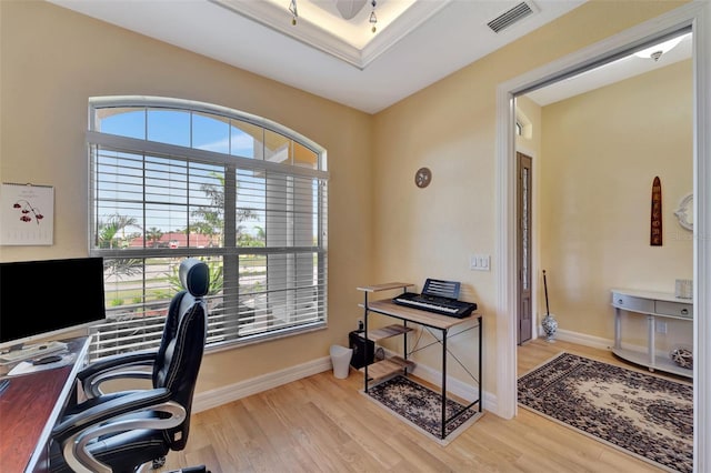 home office featuring light wood-type flooring, a wealth of natural light, and ceiling fan