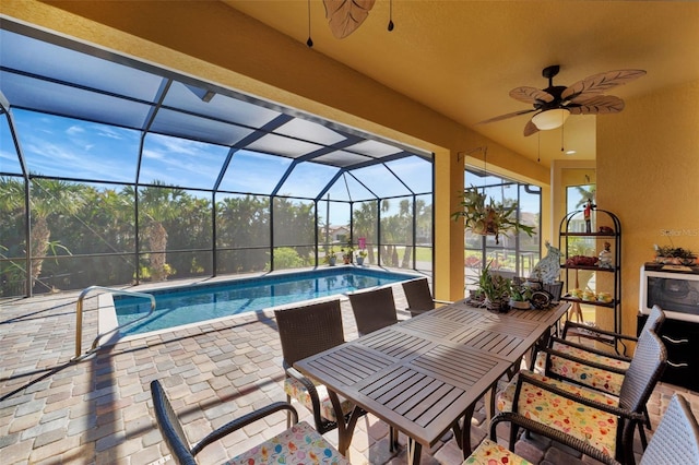 view of pool featuring a lanai, ceiling fan, and a patio area