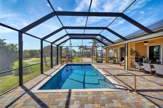 view of pool featuring a patio, ceiling fan, and a lanai