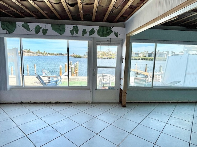 unfurnished sunroom with a water view