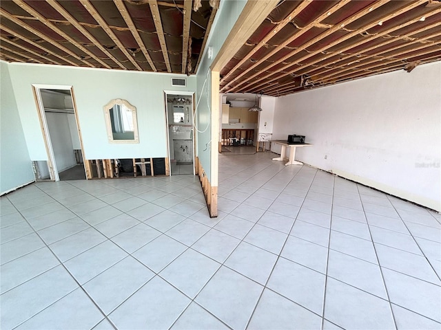 basement with light tile patterned flooring