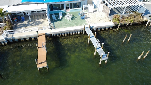 view of dock featuring a patio and a water view