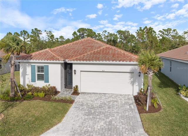 view of front of house featuring a garage and a front lawn