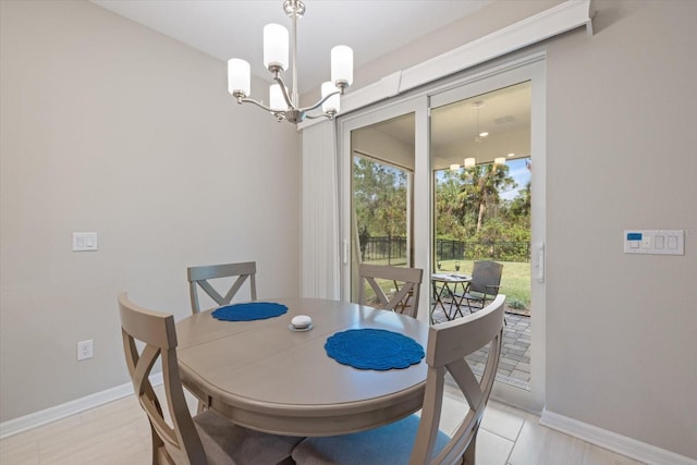 tiled dining room with a chandelier