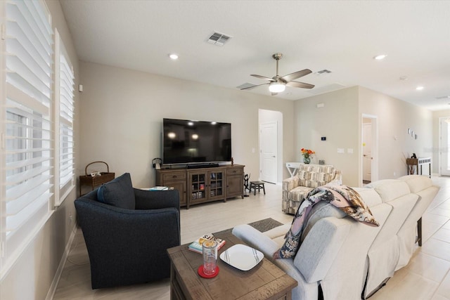 living room featuring ceiling fan and light tile patterned floors