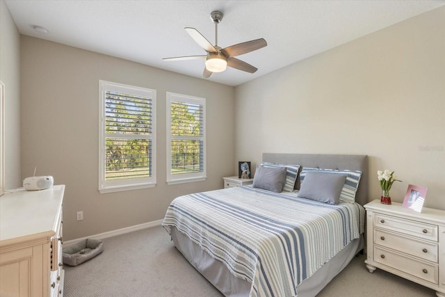 bedroom with light carpet and ceiling fan