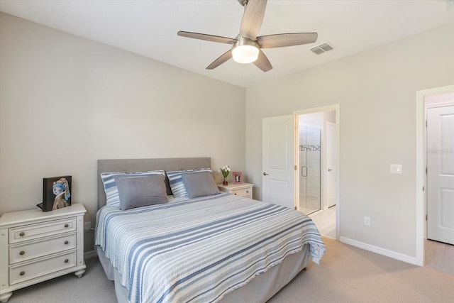 bedroom with ensuite bathroom, ceiling fan, and light carpet