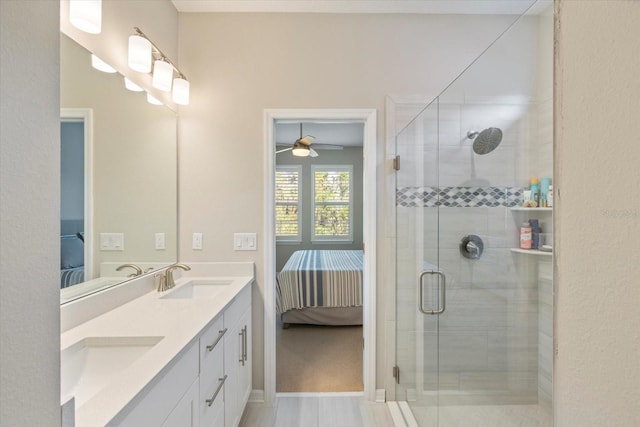 bathroom featuring ceiling fan, a shower with door, vanity, and wood-type flooring