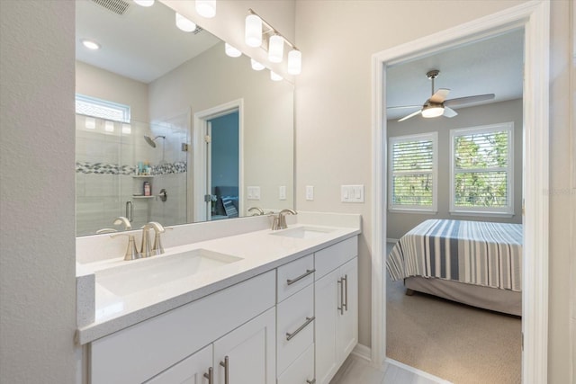 bathroom with ceiling fan, a shower with shower door, and vanity