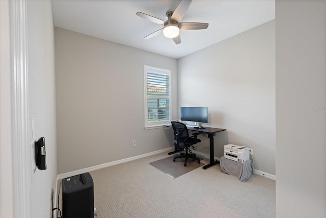 carpeted office featuring ceiling fan